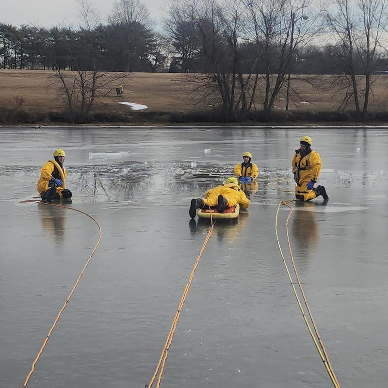 Firefighters performing ice rescue training in Mill Creek Park.