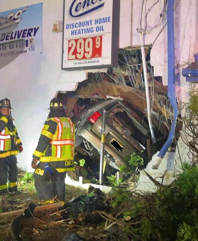 Firefighters Centrone and Child on location in Burlington City for a vehicle that went into the building.