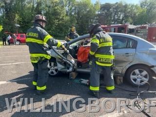 Firefighters Carcasio and Sierra under direction of Captain Costello begin extrication of patient. 