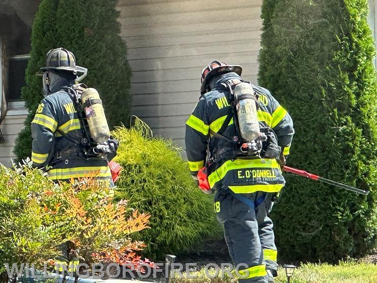 Firefighter Centrone and Lieutenant O'Donnell prepare to enter the home