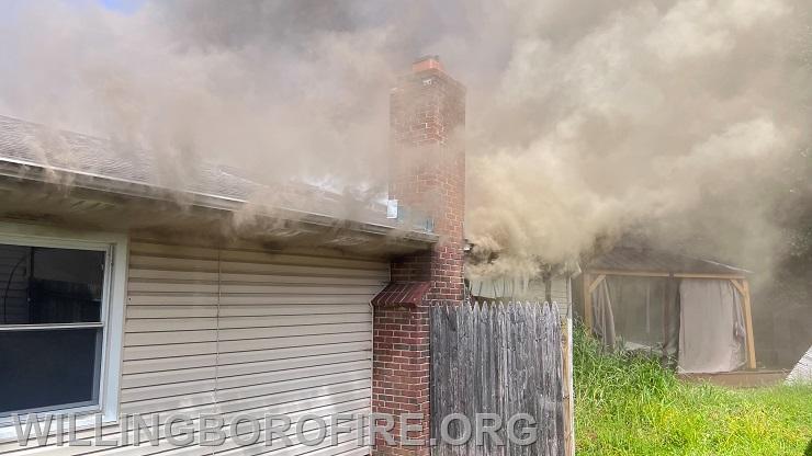 Smoke showing from the side of the home
